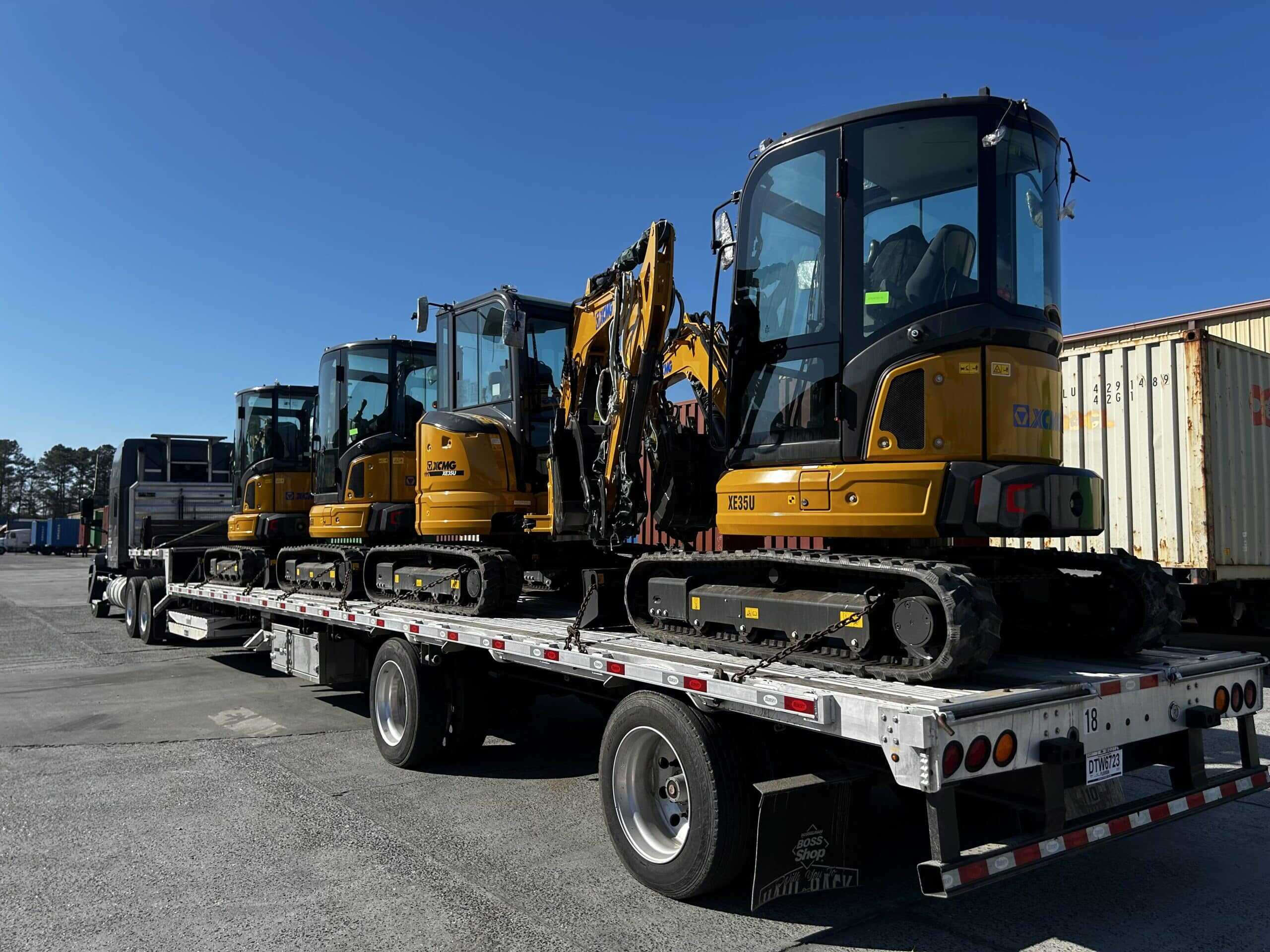 Freight Girlz hauling excavators on step deck trailer