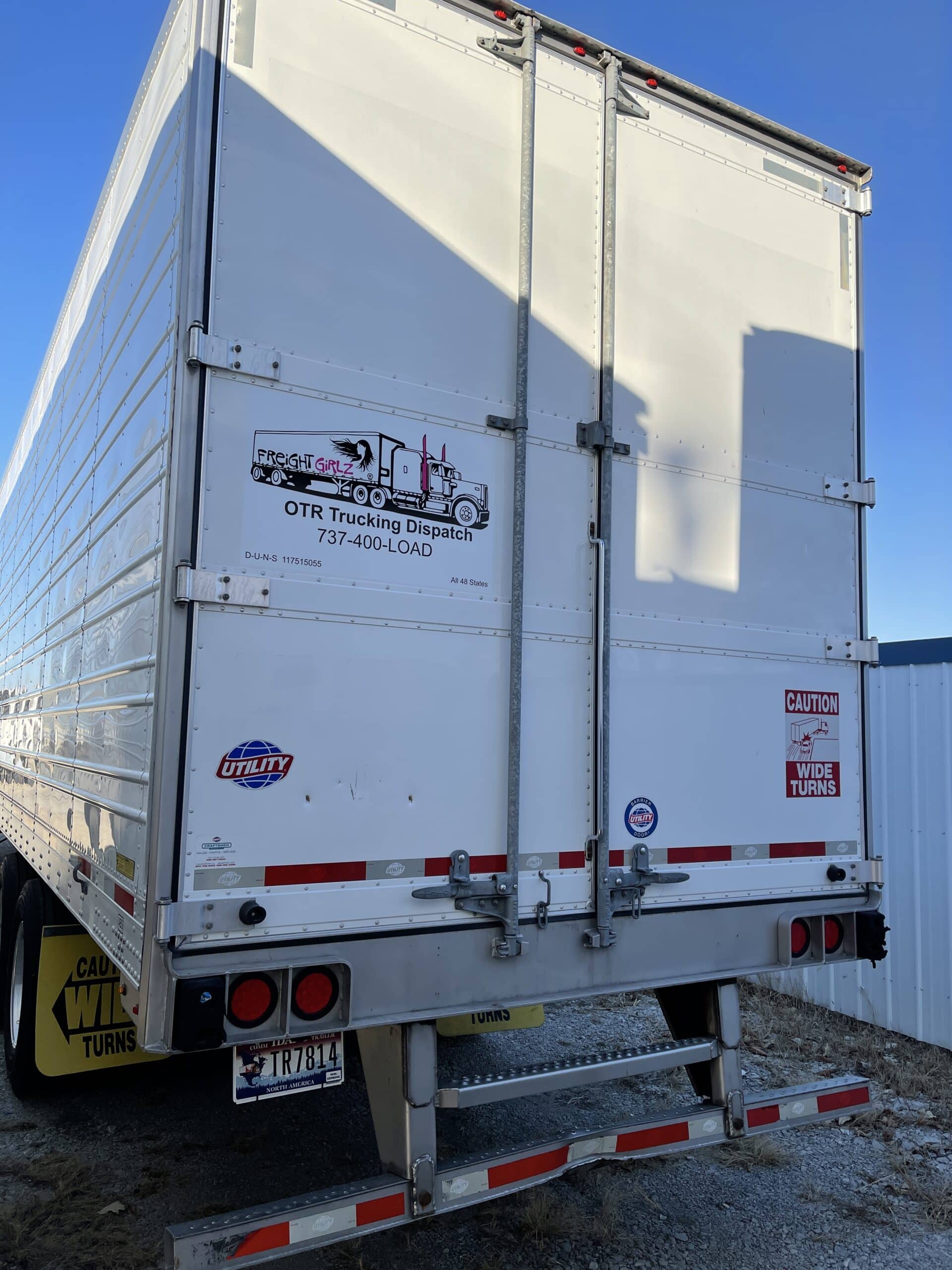 Freight Girlz dispatcher Abby and team working on dispatch operations beside a branded truck